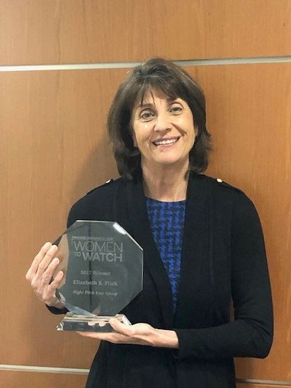 Image of Attorney Elizabeth Fitch holding Women to Watch Award